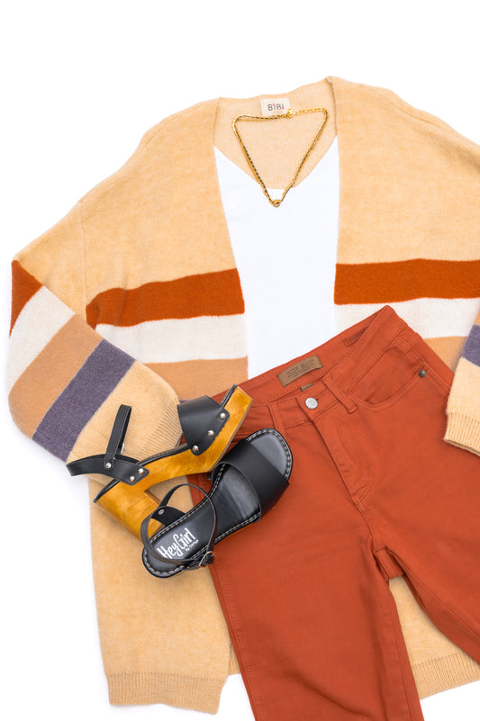 beige cardigan with terracotta colored jeans and shoes in flatlay display